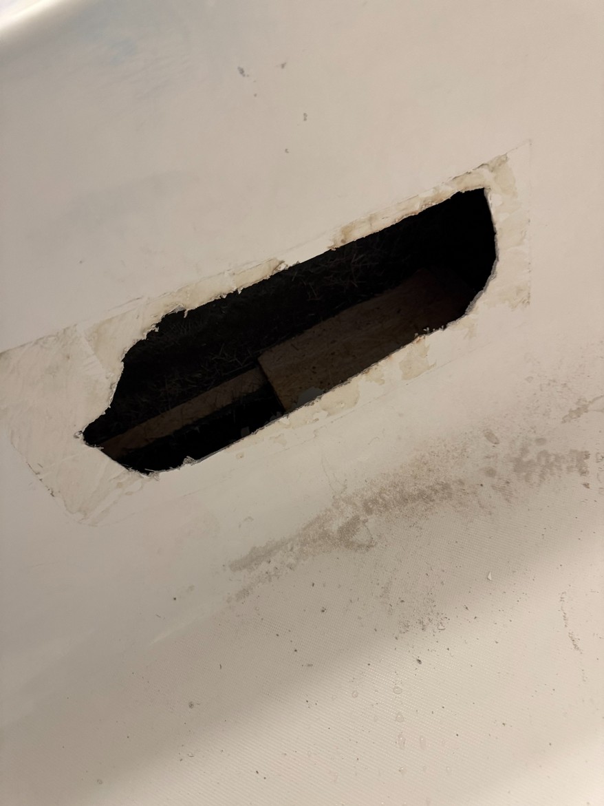 Bathtub with major structural opening before repair